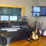 Recording studion with piano, speakers, guitar