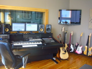 Recording studion with piano, speakers, guitar