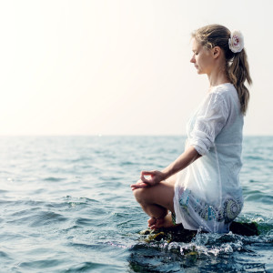 Woman meditating in the sea