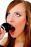 close view of woman singing into karaoke