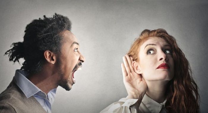 Man shouting to a woman listening