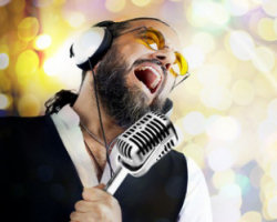 man singing with microphone and headset